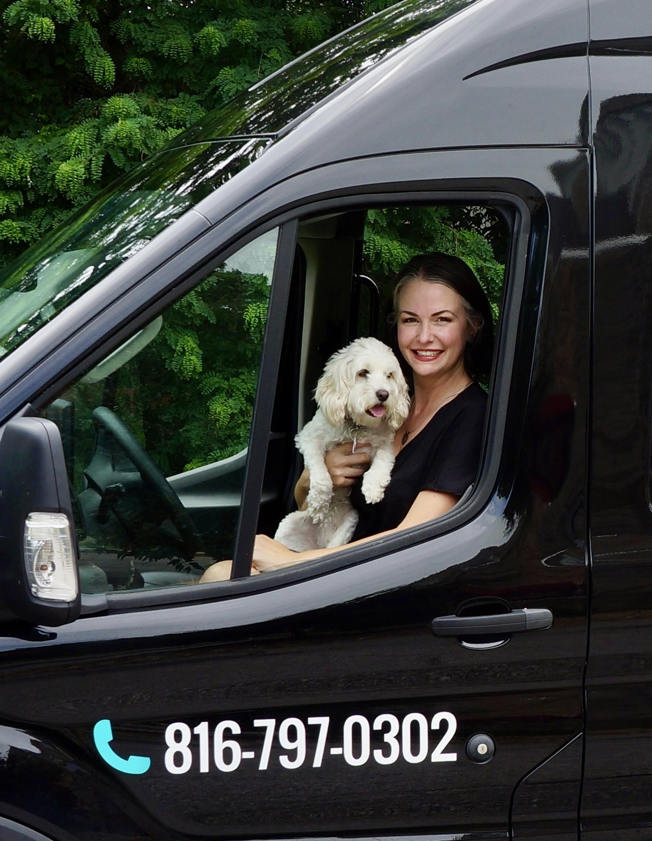 Lauren with a dog in the Spirited Dog Solutions training van